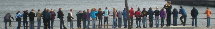 Students lined up along the shore