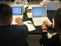 Students collaborating with computers in a 21st Century Classroom