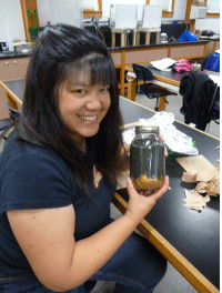 April Ann Fong, a Portland Community College instructor, shows off the Winogradsky column she made during the Ocean Bacteria session