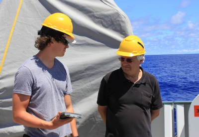 Dr. Kelvin Richards talks with a student onboard R/V Falkor